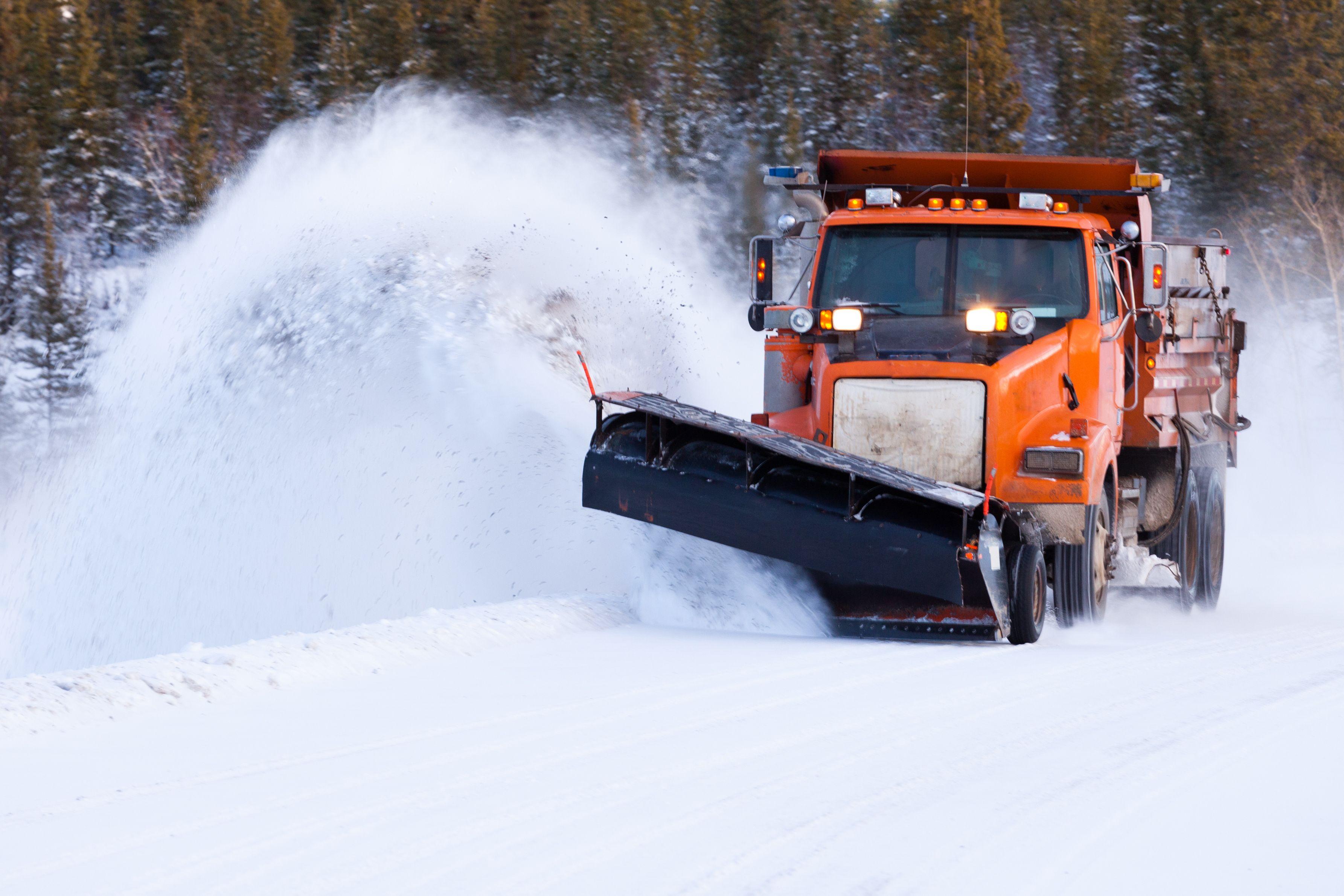 Snow plow driving through snow